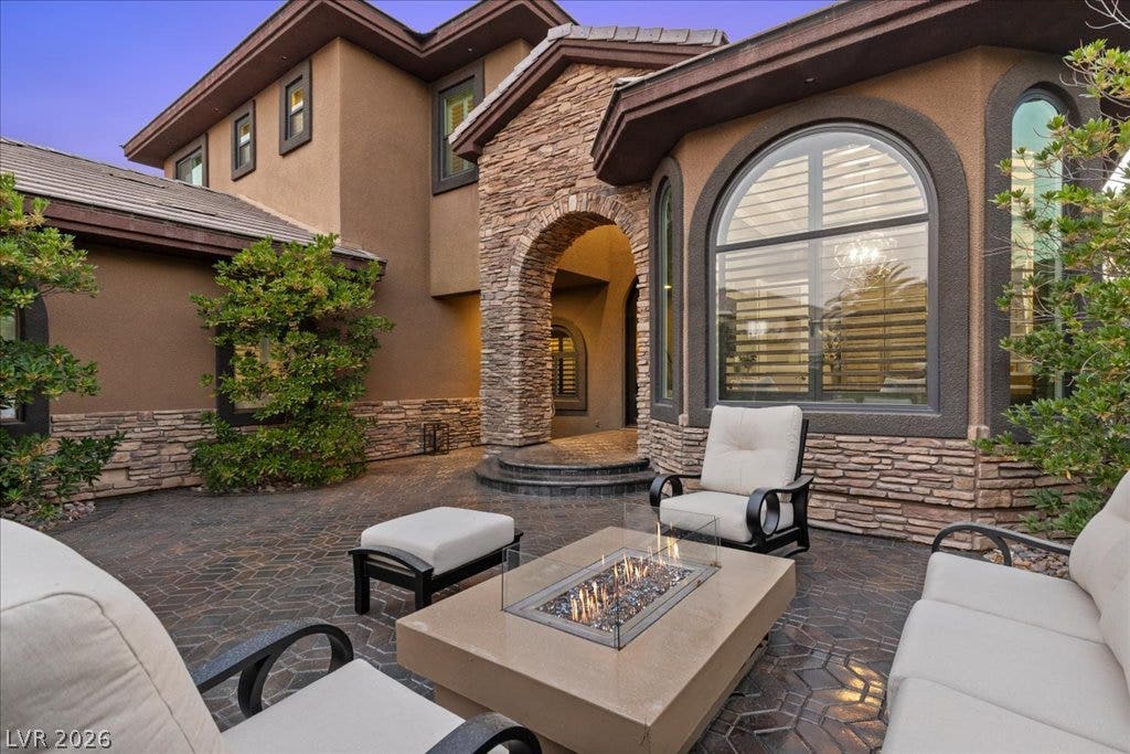 2985 American River Lane, Las Vegas, NV 89135 Stone fire pit creates a cozy outdoor gathering space.