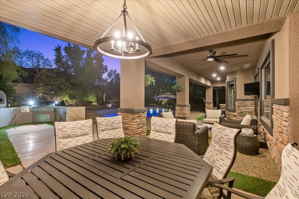 2985 American River Lane, Las Vegas, NV 89135 Outdoor kitchen and dining area perfect for gatherings.