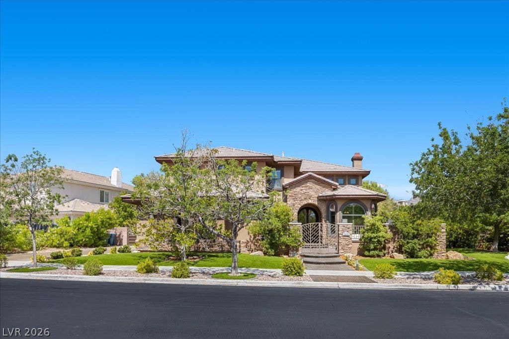 2985 American River Lane, Las Vegas, NV 89135 Inviting exterior featuring stone accents and lush landscaping.