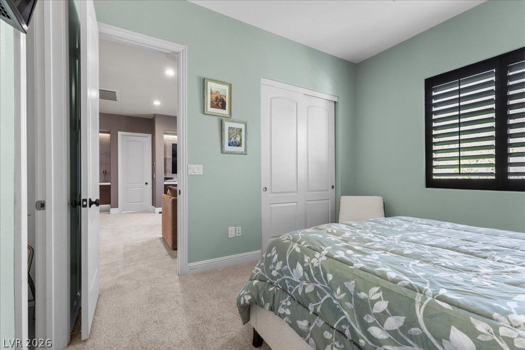 2985 American River Lane, Las Vegas, NV 89135 Bright bedroom with soft carpet and classic shutters.