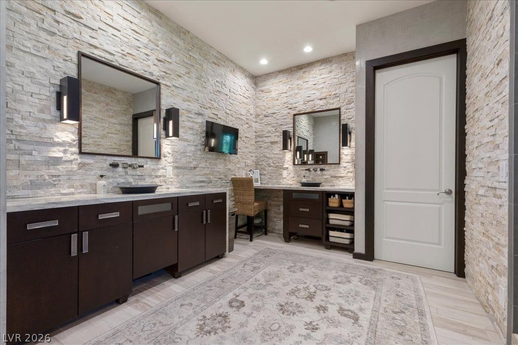 2985 American River Lane, Las Vegas, NV 89135 Spacious bathroom featuring dual vanities and upgraded finishes.