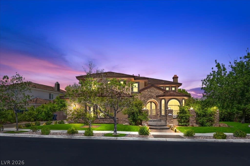 2985 American River Lane, Las Vegas, NV 89135 Elegant home showcasing detailed stonework and lush landscaping.