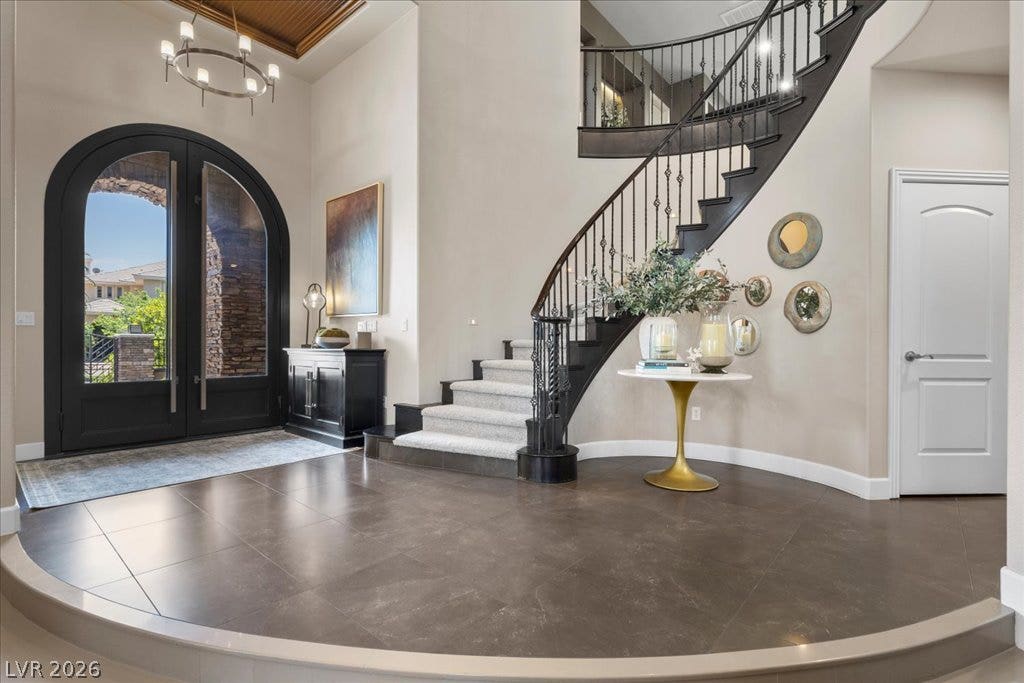2985 American River Lane, Las Vegas, NV 89135 Elegant foyer featuring a sweeping curved staircase.