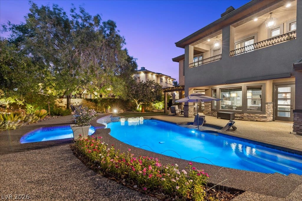 2985 American River Lane, Las Vegas, NV 89135 Backyard oasis with a luminous pool and cozy patio.