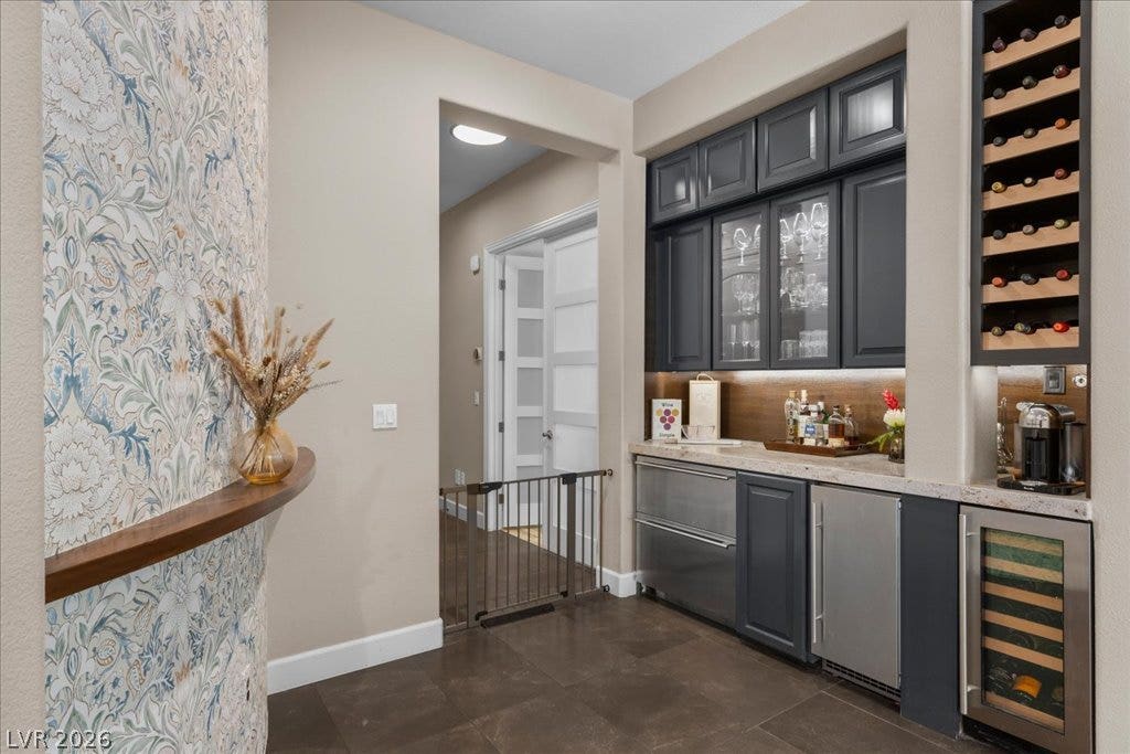 2985 American River Lane, Las Vegas, NV 89135 Stylish wet bar with integrated appliances and storage.