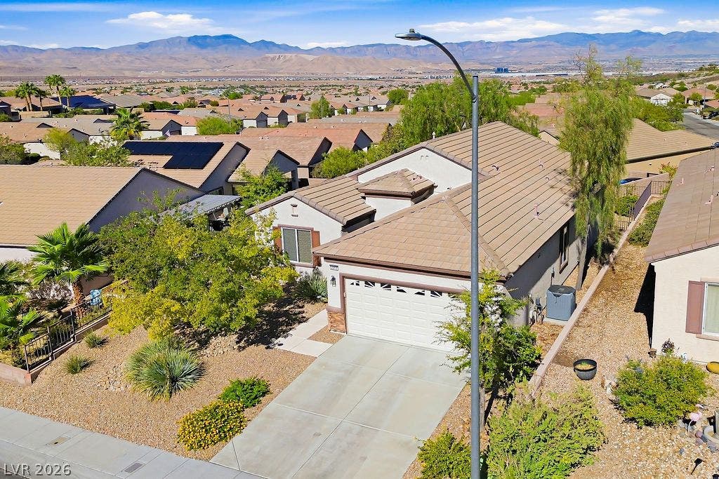 2510 Hamonah Drive, Henderson, NV 89044 Nestled in a peaceful neighborhood, a concrete driveway leads to the front-entry garage.