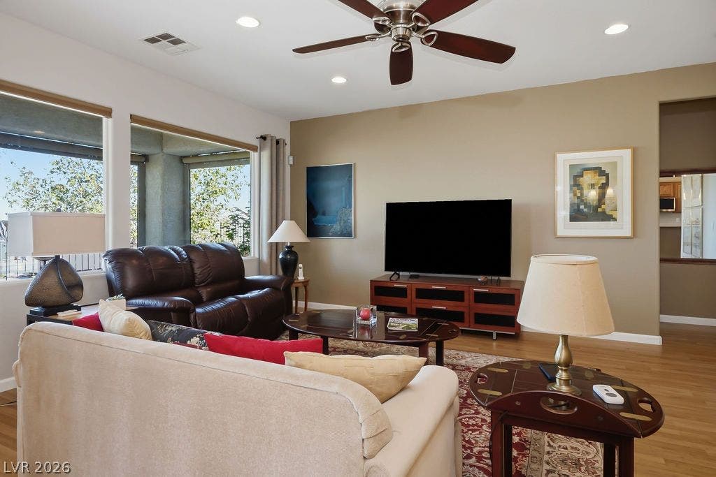 2510 Hamonah Drive, Henderson, NV 89044 Warm hardwood flooring and recessed lighting define this welcoming living space with large windows.