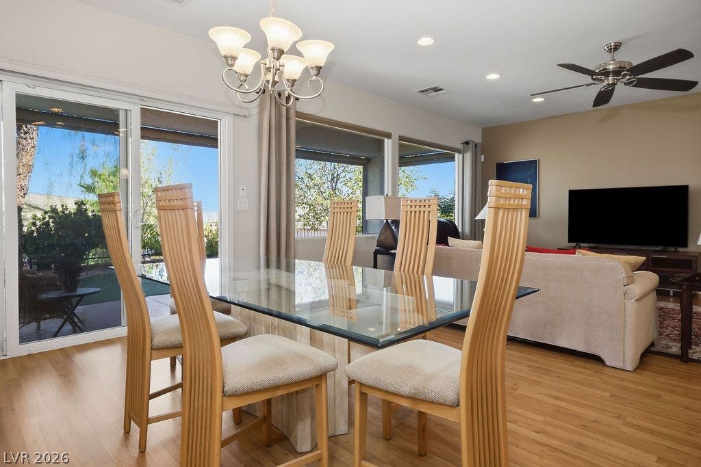 2510 Hamonah Drive, Henderson, NV 89044 Gleaming wood floors anchor an airy dining area flanked by glass sliding doors.