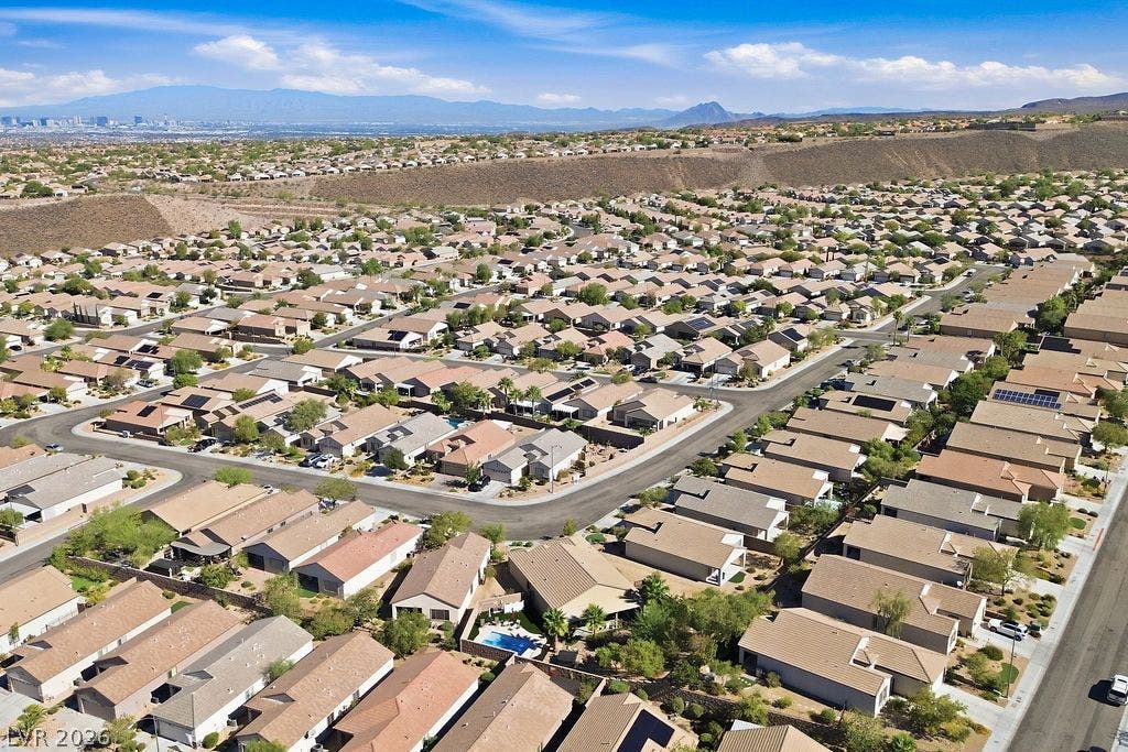 2510 Hamonah Drive, Henderson, NV 89044 A sweeping aerial view showcases the vast desert neighborhood against a distant mountain backdrop.