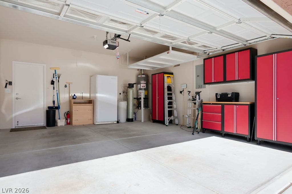 2510 Hamonah Drive, Henderson, NV 89044 A spacious garage features durable concrete flooring, custom cabinetry, and integrated overhead storage shelves.