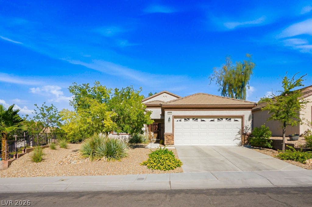 2510 Hamonah Drive, Henderson, NV 89044 Desert landscaping and a paved driveway complement this classic tile-roof residence.