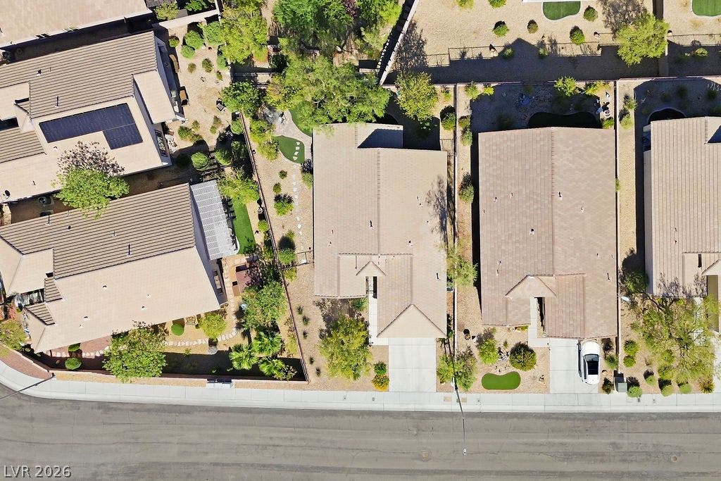 2510 Hamonah Drive, Henderson, NV 89044 An aerial perspective showcases the tile rooflines and paved driveways of suburban neighborhood residences.