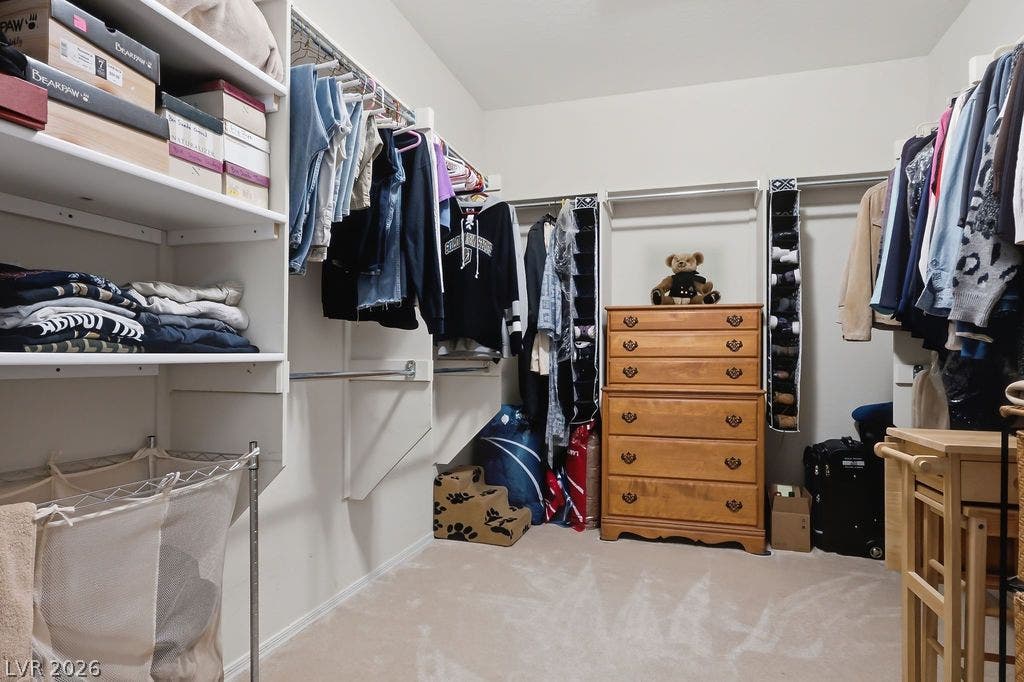 2510 Hamonah Drive, Henderson, NV 89044 Ample storage options define this functional walk-in closet featuring neutral carpeting throughout.