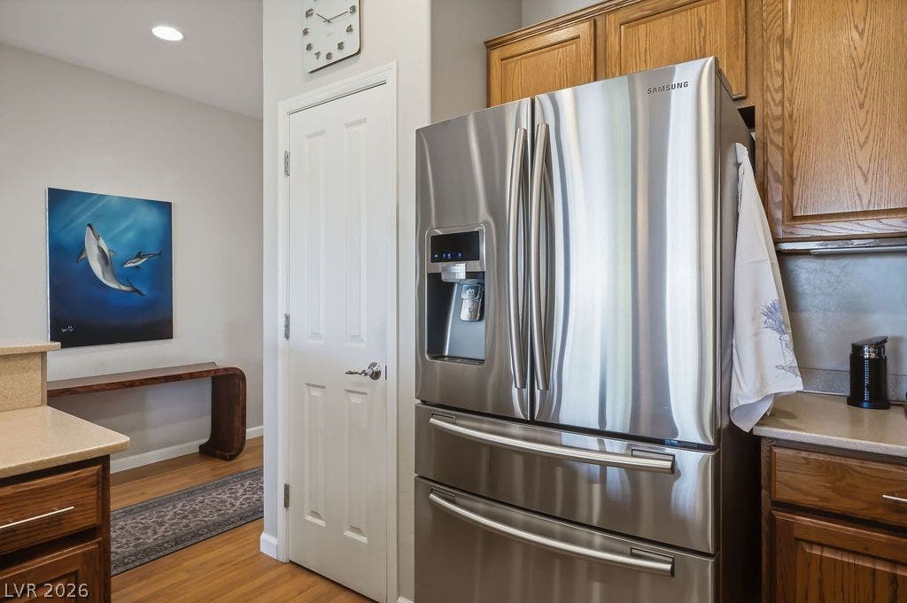 2510 Hamonah Drive, Henderson, NV 89044 Warm wood cabinetry and stainless steel appliances define this efficient kitchen space with recessed lighting.