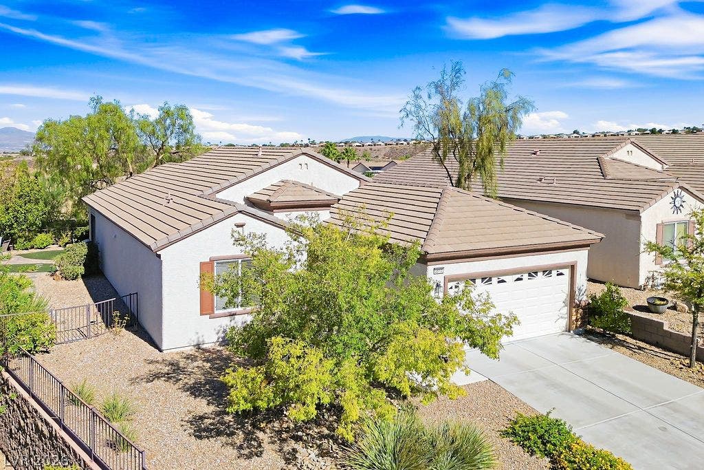 2510 Hamonah Drive, Henderson, NV 89044 Classic tile roofing and structured stucco walls anchor this inviting single-level neighborhood residence.