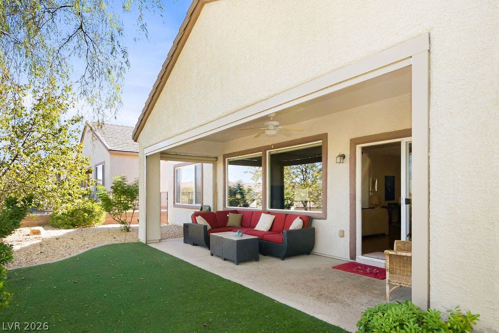 2510 Hamonah Drive, Henderson, NV 89044 A sheltered back patio opens to manicured green turf and a desert-inspired yard.