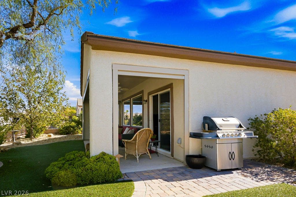 2510 Hamonah Drive, Henderson, NV 89044 An inviting covered patio opens to a stone paver path and manicured yard space.