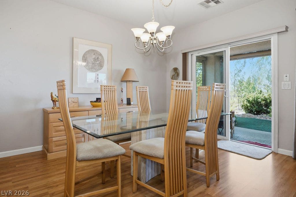 2510 Hamonah Drive, Henderson, NV 89044 Warm wood flooring and sliding glass doors highlight this inviting dining space.