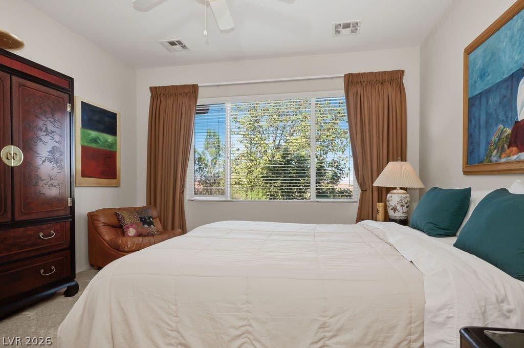 2510 Hamonah Drive, Henderson, NV 89044 Plentiful natural light streams through a wide window overlooking lush outdoor greenery.