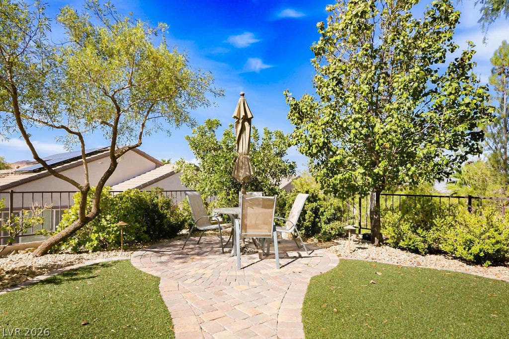 2510 Hamonah Drive, Henderson, NV 89044 A paved path leads to a circular patio space nestled among mature garden landscaping.