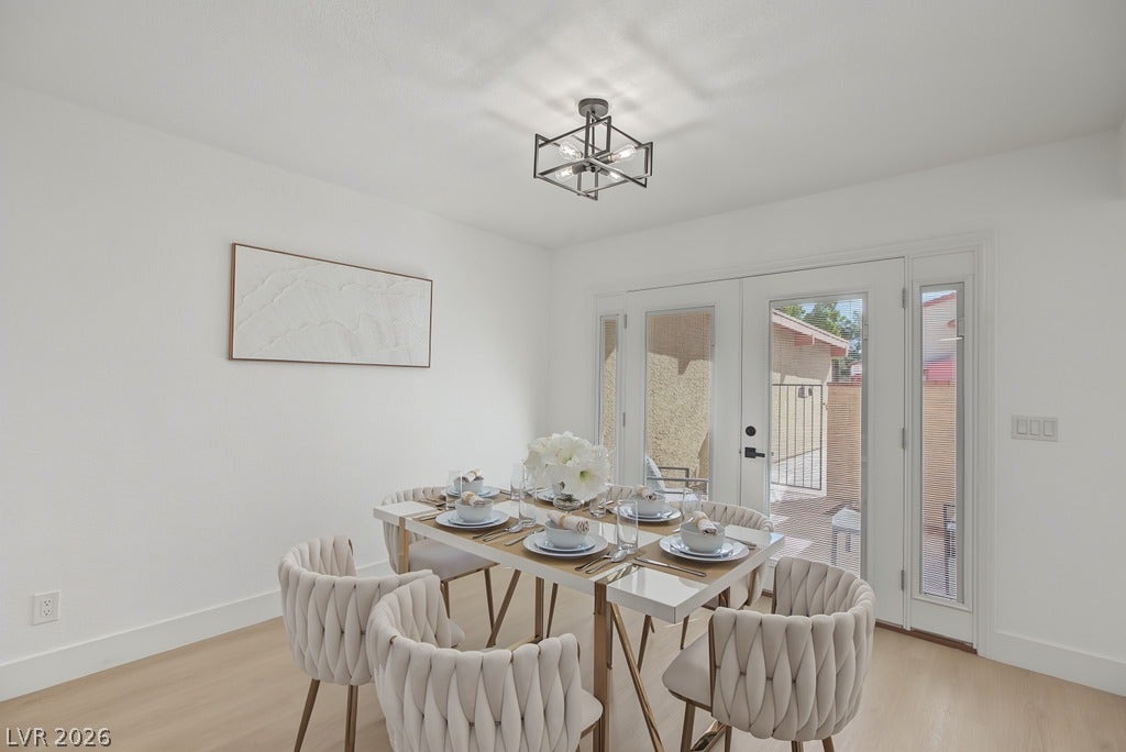 2371 Pickwick Drive, Henderson, NV 89014 Glass-paneled doors invite natural light across smooth hardwood flooring in this airy dining space.