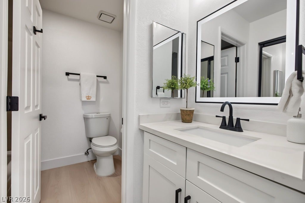 2371 Pickwick Drive, Henderson, NV 89014 A crisp white vanity and light wood flooring define this updated bathroom space.