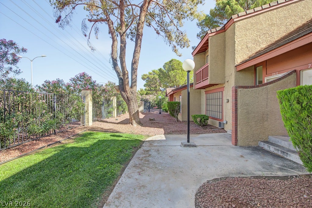 2371 Pickwick Drive, Henderson, NV 89014 Mature trees and neat green lawns border the stucco exterior of this multi-level residential building.