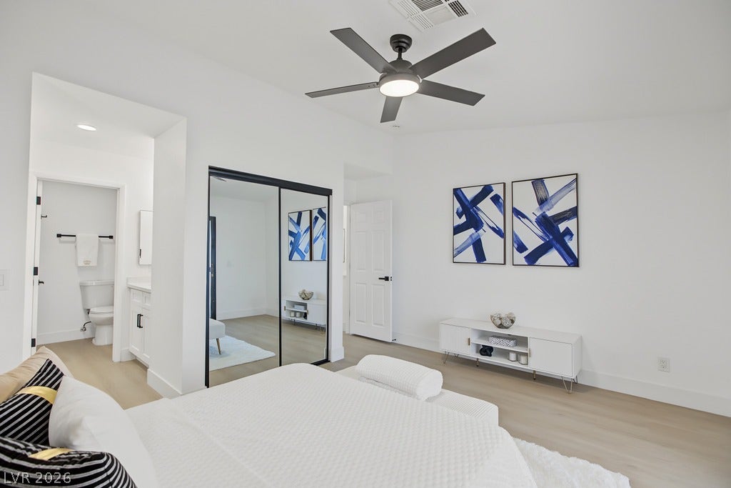 2371 Pickwick Drive, Henderson, NV 89014 Smooth wood flooring and clean white walls create a serene, minimalist bedroom retreat.