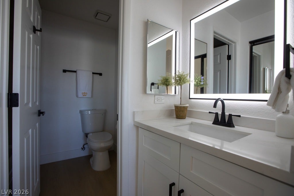 2371 Pickwick Drive, Henderson, NV 89014 An illuminated mirror accents the clean lines of this modern bathroom vanity.