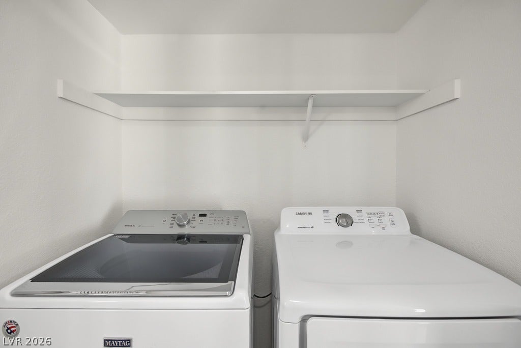 2371 Pickwick Drive, Henderson, NV 89014 A dedicated laundry nook provides practical shelving above the appliances.