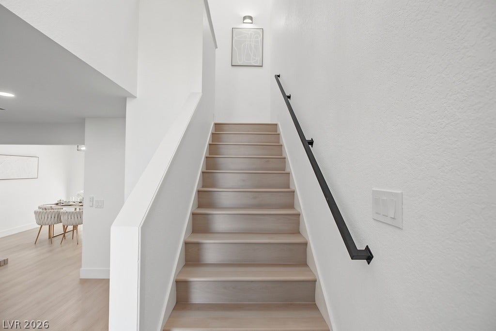 2371 Pickwick Drive, Henderson, NV 89014 Sleek hardwood stairs with a minimalist handrail ascend from the open living space.
