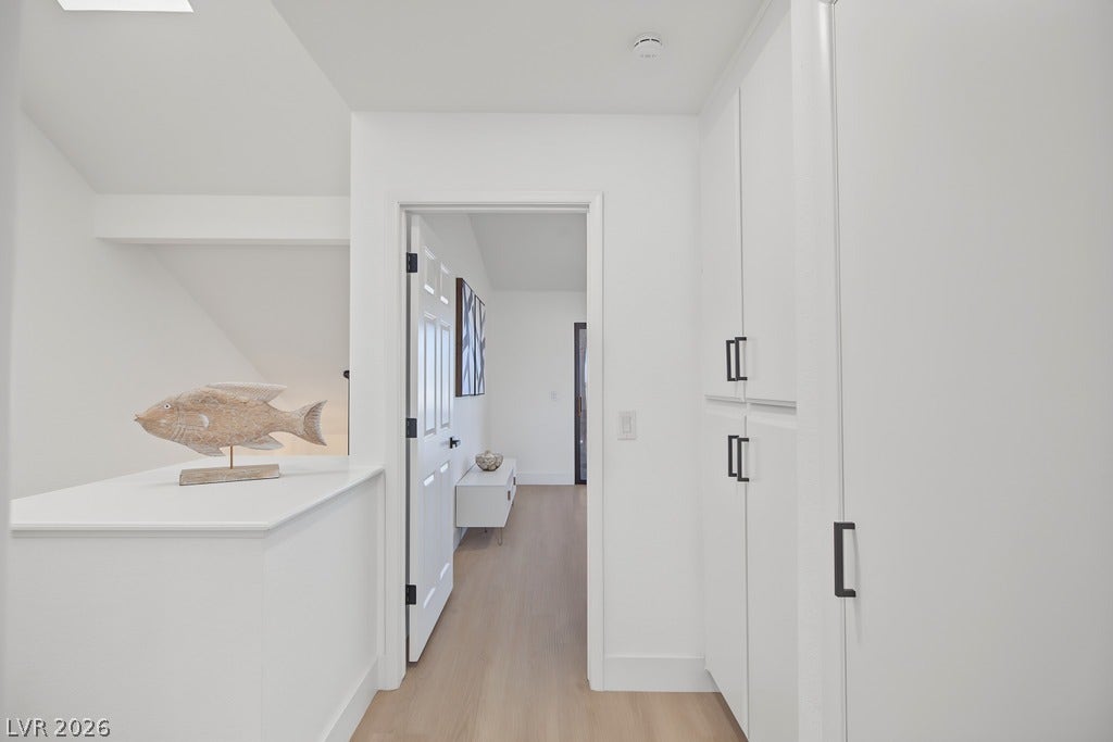2371 Pickwick Drive, Henderson, NV 89014 Streamlined built-in cabinetry and smooth wood floors define this bright hallway landing area.