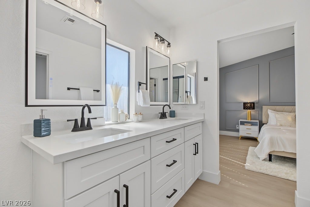 2371 Pickwick Drive, Henderson, NV 89014 Clean lines and stone counters highlight this modern double vanity bathroom adjoining the primary suite.