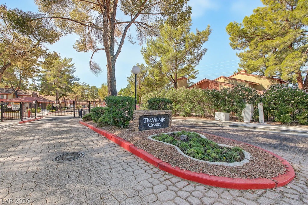 2371 Pickwick Drive, Henderson, NV 89014 Mature trees frame the secure gated entrance featuring cobblestone-patterned paving.