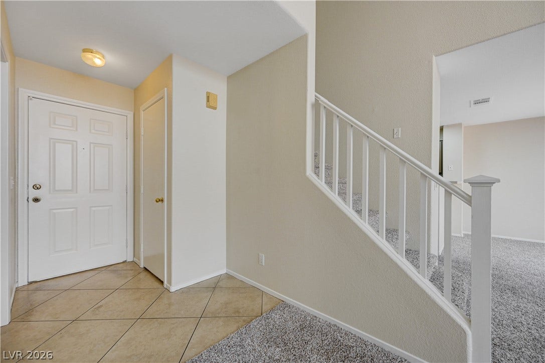 2706 Guidance Court, North Las Vegas, NV 89031 Tiled flooring and a carpeted staircase welcome guests into this open entry space.