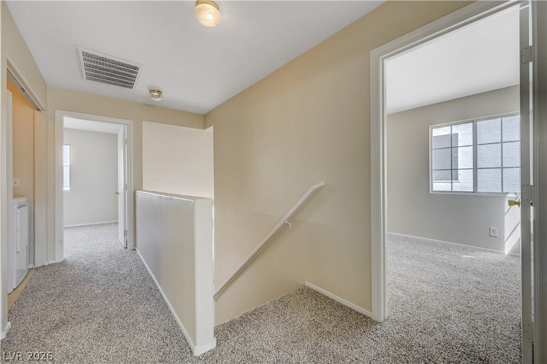 2706 Guidance Court, North Las Vegas, NV 89031 Plush carpeting and neutral-toned walls connect the upstairs bedrooms with the central staircase landing.
