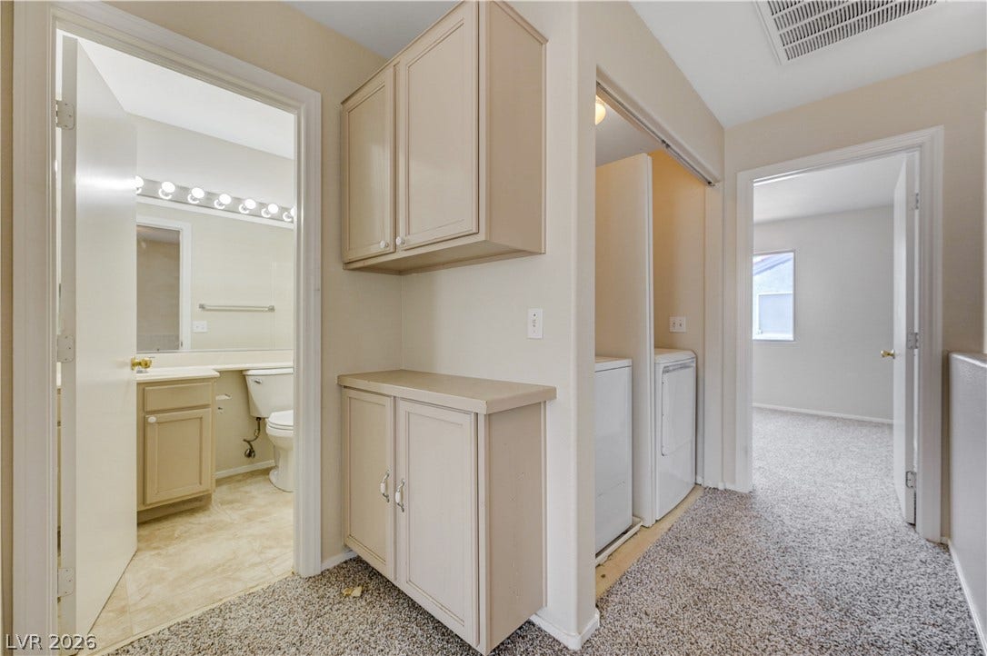 2706 Guidance Court, North Las Vegas, NV 89031 Smartly configured hallway incorporates built-in storage cabinets alongside a dedicated laundry closet.