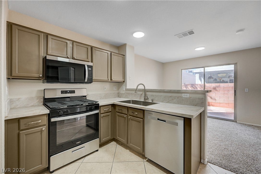 2706 Guidance Court, North Las Vegas, NV 89031 Gleaming stone counters and sleek cabinetry define this modern culinary space.