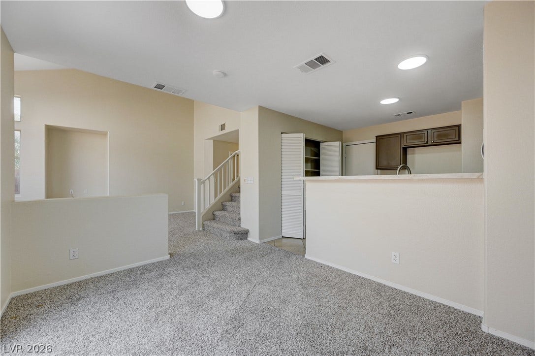 2706 Guidance Court, North Las Vegas, NV 89031 An open floor plan connects the carpeted living space directly to the kitchen area.