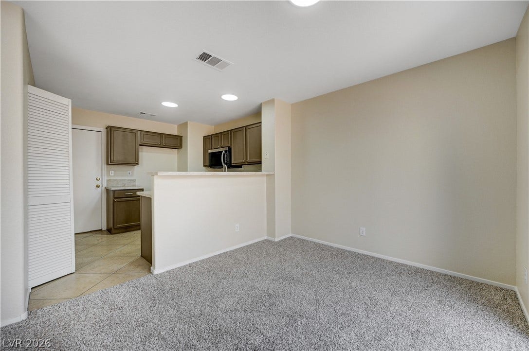 2706 Guidance Court, North Las Vegas, NV 89031 An open floor plan connects the carpeted living space directly to the kitchen area.