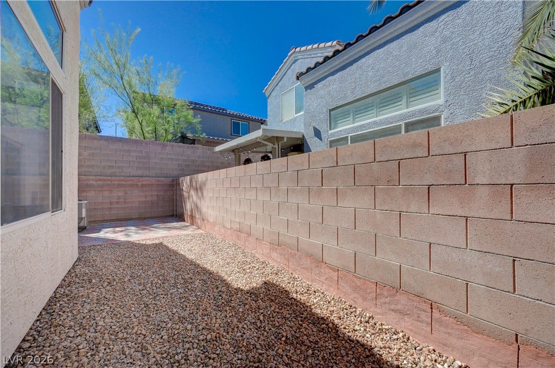 2706 Guidance Court, North Las Vegas, NV 89031 Enclosed side yard features low-maintenance gravel landscaping bordered by a sturdy privacy wall.