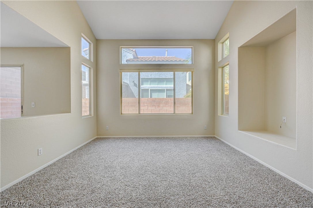 2706 Guidance Court, North Las Vegas, NV 89031 Vaulted ceilings and integrated display niches elevate this versatile, carpeted living area.
