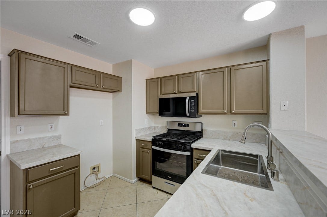 2706 Guidance Court, North Las Vegas, NV 89031 Gleaming stone countertops and classic cabinetry define this functional culinary space.