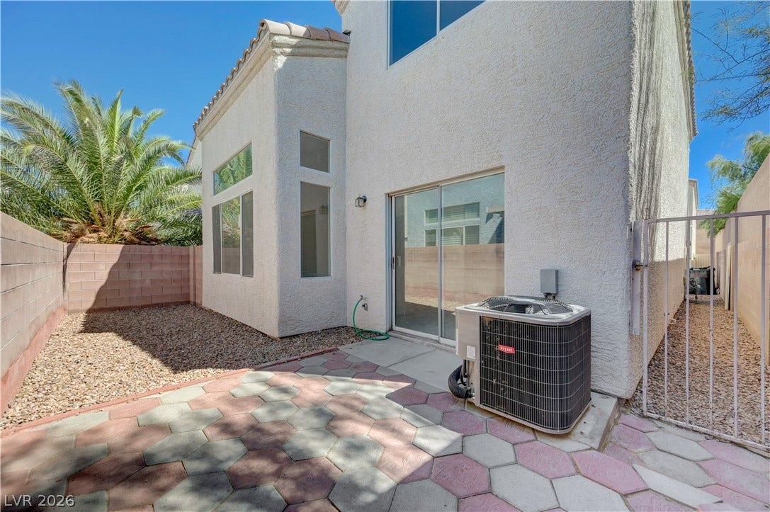 2706 Guidance Court, North Las Vegas, NV 89031 An inviting paved patio area is bordered by stucco walls under clear blue skies.