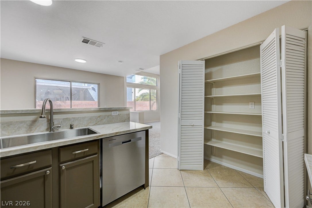 2706 Guidance Court, North Las Vegas, NV 89031 An open kitchen layout transitions into a bright living space with durable tile floors.