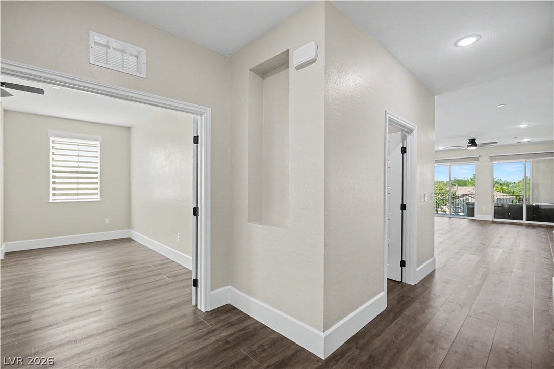 2555 Hampton Road, #11210, Henderson, NV 89052 Gleaming LVP flooring anchor a versatile open-plan layout connecting several functional living spaces.