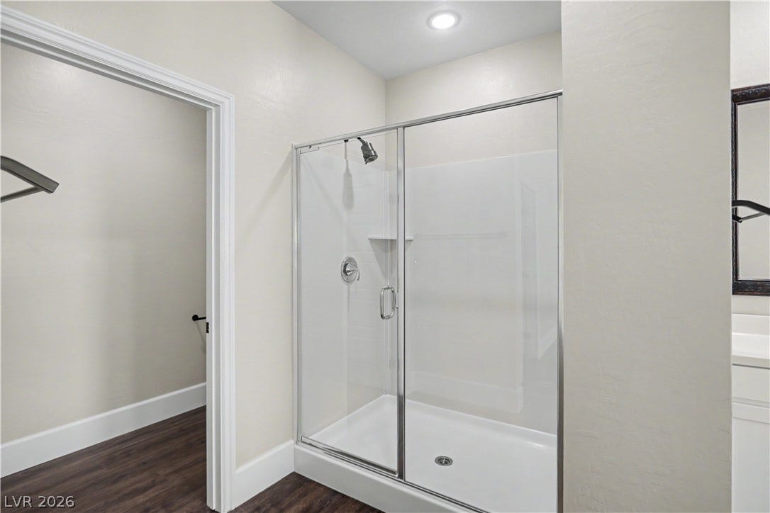 2555 Hampton Road, #11210, Henderson, NV 89052 A modern walk-in shower and a private water closet complete this stylish primary bathroom.