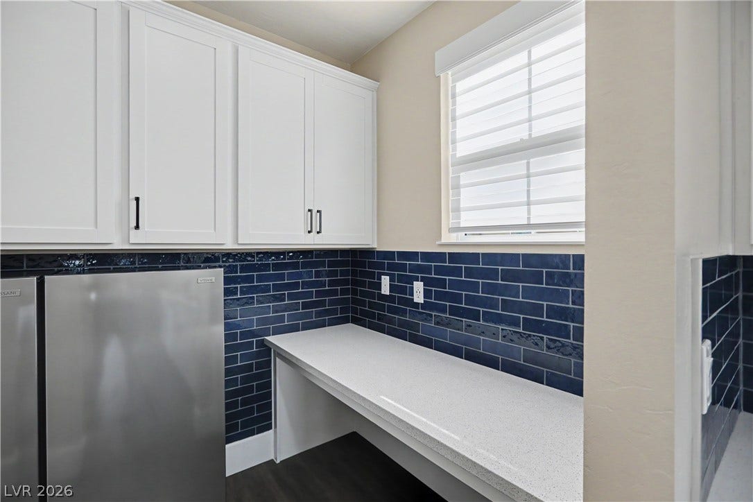 2555 Hampton Road, #11210, Henderson, NV 89052 This handy workspace off the kitchen offers a built-in desk, extra cabinet storage, and outlets for charging devices.
