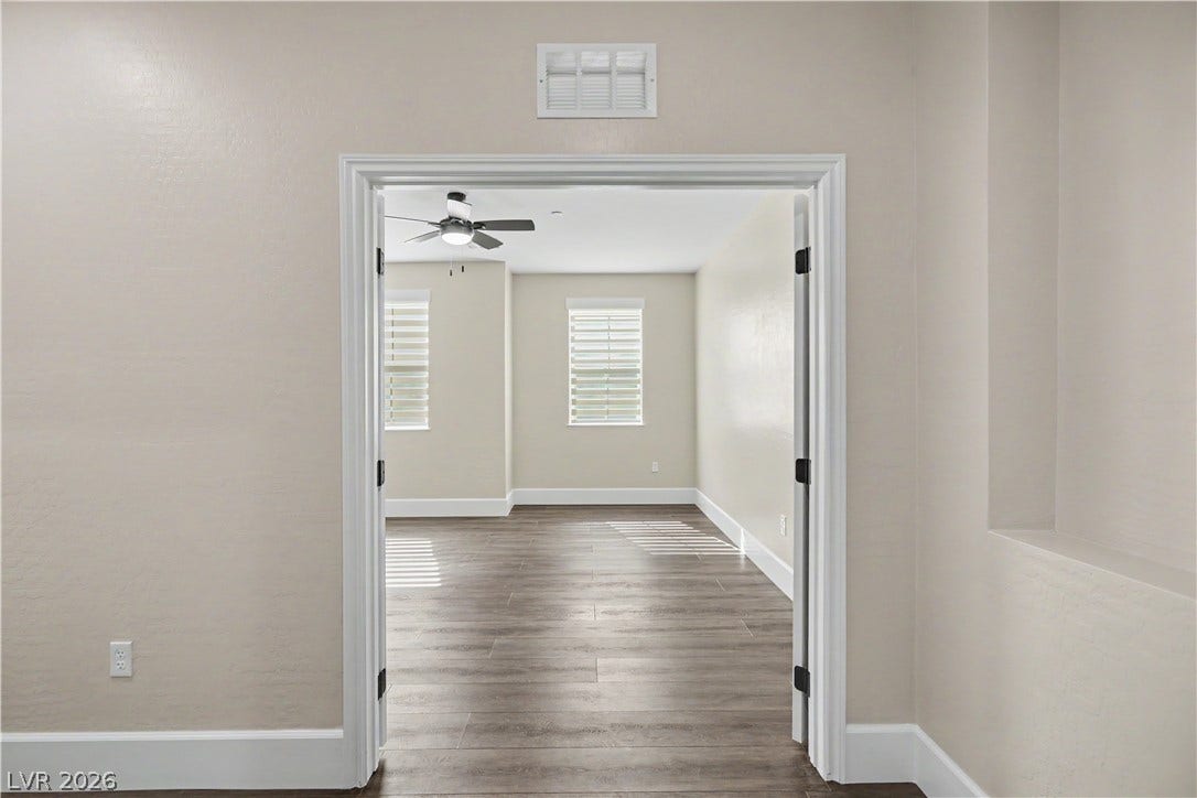2555 Hampton Road, #11210, Henderson, NV 89052 Double doors open to a spacious den/ office with classic LVP flooring and neat white trim.