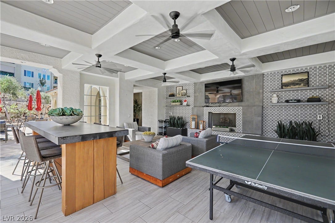 2555 Hampton Road, #11210, Henderson, NV 89052 Right next to the community pool, this resort-style outdoor living space is perfect for hanging out with friends, with lounge seating, high-top tables, ceiling fans and a cozy fireplace.
